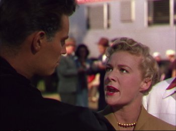 Movie still from “The Greatest Show on Earth” (1952), directed by Cecil B. DeMille – An older woman talking to a younger man in front of a crowd; Medium shot, Low angle