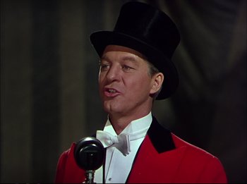 Movie still from “The Greatest Show on Earth” (1952), directed by Cecil B. DeMille – A man wearing a red jacket and a black top hat; Close Up shot, Low angle