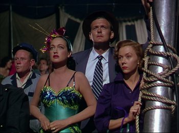 Movie still from “The Greatest Show on Earth” (1952), directed by Cecil B. DeMille – A man and two women standing next to each other; Medium shot, Low angle