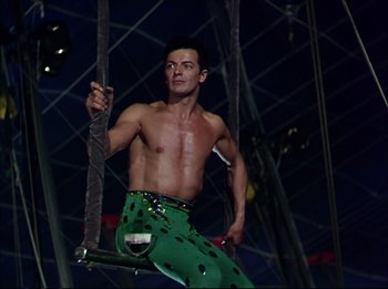 Movie still from “The Greatest Show on Earth” (1952), directed by Cecil B. DeMille – A man in green pants is on a swing; Medium shot, Low angle