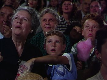 Movie still from “The Greatest Show on Earth” (1952), directed by Cecil B. DeMille – A group of people sitting in front of an audience; Medium shot, Low angle