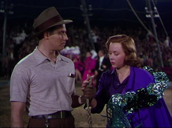 Movie still from “The Greatest Show on Earth” (1952), directed by Cecil B. DeMille – A man and a woman holding onto a chain; Medium shot, Low angle