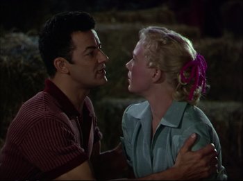 Movie still from “The Greatest Show on Earth” (1952), directed by Cecil B. DeMille – A man and a woman standing next to each other; Medium shot, Low angle