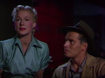 Movie still from “The Greatest Show on Earth” (1952), directed by Cecil B. DeMille – A man and a woman sitting next to each other; Medium shot, Low angle