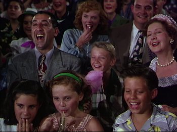 Movie still from “The Greatest Show on Earth” (1952), directed by Cecil B. DeMille – A group of people sitting in front of each other; Medium shot, Low angle