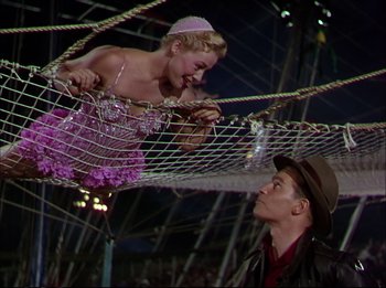 Movie still from “The Greatest Show on Earth” (1952), directed by Cecil B. DeMille – A man and a woman are hanging on a rope bridge; Medium shot, Low angle