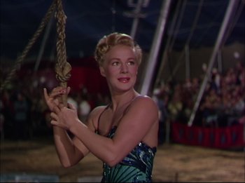 Movie still from “The Greatest Show on Earth” (1952), directed by Cecil B. DeMille – A beautiful woman holding a rope in front of an audience; Medium shot, Low angle