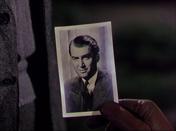 Movie still from “The Greatest Show on Earth” (1952), directed by Cecil B. DeMille – An old photo of a man in a suit and tie; Close Up shot, Over the shoulder angle