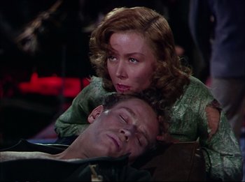 Movie still from “The Greatest Show on Earth” (1952), directed by Cecil B. DeMille – A man and a woman laying on the ground; Medium shot, High angle