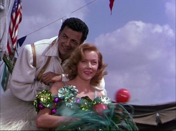 Movie still from “The Greatest Show on Earth” (1952), directed by Cecil B. DeMille – A man standing next to a beautiful woman; Medium shot, Low angle