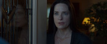 Movie still from “The Guest” (2014), directed by Adam Wingard – A person with long dark hair; Close Up shot, Over the shoulder angle