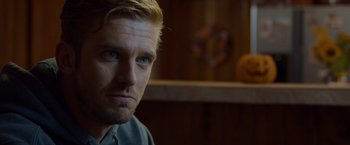 Movie still from “The Guest” (2014), directed by Adam Wingard – A person wearing a blue shirt; Close Up shot, Over the shoulder angle