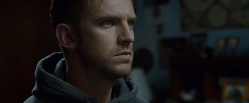 Movie still from “The Guest” (2014), directed by Adam Wingard – A person looking at the camera; Close Up shot, Over the shoulder angle