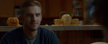 Movie still from “The Guest” (2014), directed by Adam Wingard – A person sitting at a table in a kitchen; Close Up shot, Over the shoulder angle