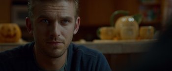 Movie still from “The Guest” (2014), directed by Adam Wingard – A man's face in a kitchen; Close Up shot, Over the shoulder angle