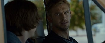 Movie still from “The Guest” (2014), directed by Adam Wingard – A man sitting in the back seat of a car; Close Up shot, Over the shoulder angle