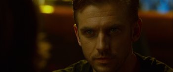 Movie still from “The Guest” (2014), directed by Adam Wingard – A person with green eyes; Close Up shot, Over the shoulder angle