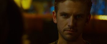 Movie still from “The Guest” (2014), directed by Adam Wingard – A man's face in a dark room; Close Up shot, Over the shoulder angle