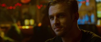 Movie still from “The Guest” (2014), directed by Adam Wingard – A man's face in the dark; Close Up shot, Over the shoulder angle
