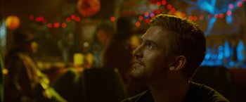 Movie still from “The Guest” (2014), directed by Adam Wingard – A person sitting in a room; Close Up shot, Over the shoulder angle