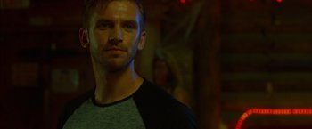 Movie still from “The Guest” (2014), directed by Adam Wingard – A person wearing a black and grey shirt; Close Up shot, Over the shoulder angle