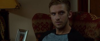 Movie still from “The Guest” (2014), directed by Adam Wingard – A person sitting in a chair; Close Up shot, Over the shoulder angle
