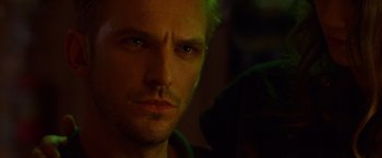 Movie still from “The Guest” (2014), directed by Adam Wingard – A man's face in the dark; Close Up shot, Over the shoulder angle