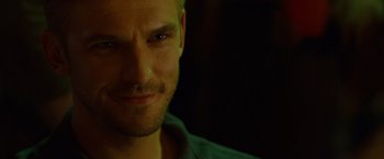 Movie still from “The Guest” (2014), directed by Adam Wingard – A man's face in the dark; Close Up shot, Over the shoulder angle