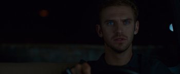 Movie still from “The Guest” (2014), directed by Adam Wingard – A person holding a remote control; Close Up shot, Over the shoulder angle