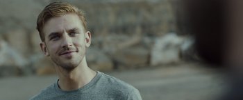 Movie still from “The Guest” (2014), directed by Adam Wingard – A person wearing a gray t - shirt; Close Up shot, Over the shoulder angle