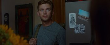 Movie still from “The Guest” (2014), directed by Adam Wingard – A man with a backpack standing next to a refrigerator; Close Up shot, Over the shoulder angle