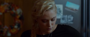 Movie still from “The Guest” (2014), directed by Adam Wingard – A woman with blonde hair is looking down at her face; Close Up shot, Over the shoulder angle