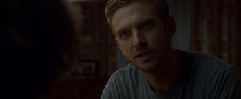 Movie still from “The Guest” (2014), directed by Adam Wingard – A person wearing a gray shirt; Close Up shot, Over the shoulder angle