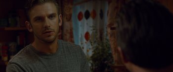 Movie still from “The Guest” (2014), directed by Adam Wingard – A person wearing a gray t - shirt; Close Up shot, Over the shoulder angle