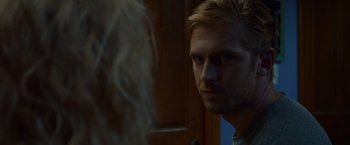 Movie still from “The Guest” (2014), directed by Adam Wingard – A person looking at the camera; Close Up shot, Over the shoulder angle