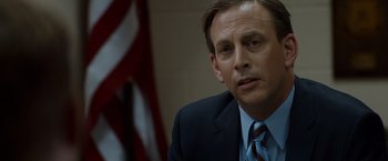 Movie still from “The Guest” (2014), directed by Adam Wingard – A person wearing a suit and tie; Close Up shot, Over the shoulder angle