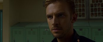 Movie still from “The Guest” (2014), directed by Adam Wingard – A man's face in front of green lockers; Close Up shot, Over the shoulder angle