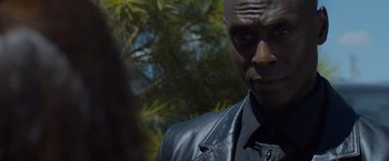 Movie still from “The Guest” (2014), directed by Adam Wingard – A person wearing a suit and tie; Close Up shot, Over the shoulder angle