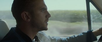 Movie still from “The Guest” (2014), directed by Adam Wingard – A person looking out a car window; Close Up shot, Over the shoulder angle