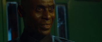 Movie still from “The Guest” (2014), directed by Adam Wingard – A man's face in a dark room; Close Up shot, Low angle