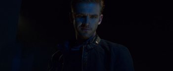Movie still from “The Guest” (2014), directed by Adam Wingard – A young man with blue light on his face; Close Up shot, Low angle