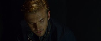Movie still from “The Guest” (2014), directed by Adam Wingard – A person wearing a black jacket; Close Up shot, High angle