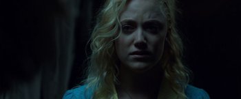 Movie still from “The Guest” (2014), directed by Adam Wingard – A woman with blonde hair is looking at the camera; Close Up shot, Over the shoulder angle