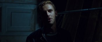 Movie still from “The Guest” (2014), directed by Adam Wingard – A person wearing a black shirt; Close Up shot, Over the shoulder angle