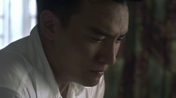 Movie still from “The Hand” (2004), directed by Kar-Wai Wong – A person wearing a white shirt; Close Up shot, Low angle