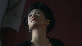 Movie still from “The Hand” (2004), directed by Kar-Wai Wong – A person wearing a hat; Close Up shot, Low angle