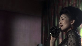 Movie still from “The Hand” (2004), directed by Kar-Wai Wong – A woman holding a phone up to her ear; Close Up shot, Low angle