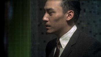 Movie still from “The Hand” (2004), directed by Kar-Wai Wong – A person wearing a suit and tie; Close Up shot, Low angle