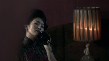 Movie still from “The Hand” (2004), directed by Kar-Wai Wong – A woman is talking on a phone in a dark room; Close Up shot, Low angle