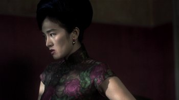 Movie still from “The Hand” (2004), directed by Kar-Wai Wong – A woman in a floral dress is looking at the camera; Close Up shot, Low angle